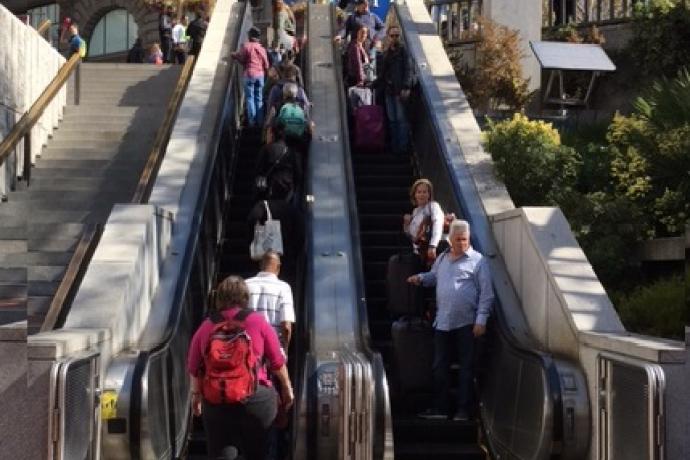 Image of people coming down a muni metro escalator at Hallidie Plaza