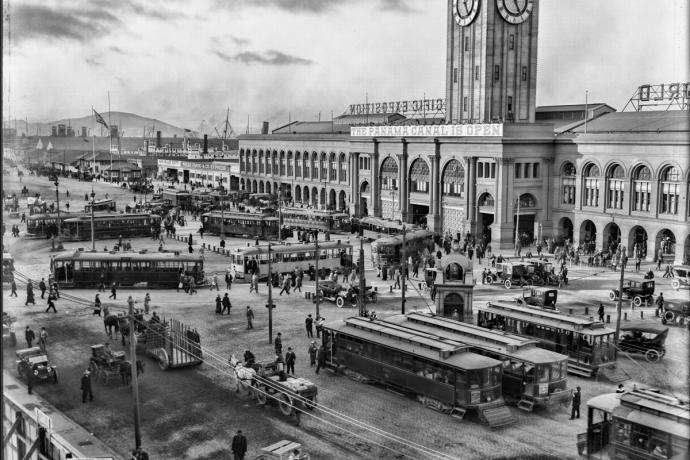 ferry building busy with people, streetcars, and autos