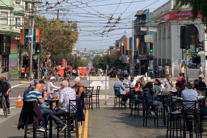 People enjoy the Shared Space at 18th and Castro streets