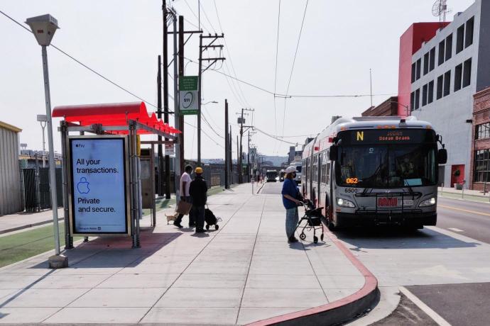 Customers boarding Muni bus on newly built sidewalk loading island on Townsend Street.