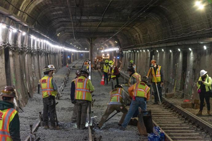 Workers laying track in the Twin Peaks tunnel