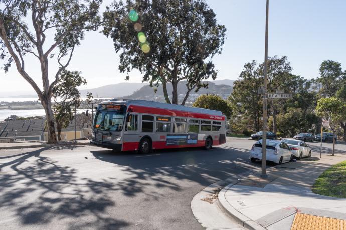 15 Bayview Hunters Point bus traveling on a street in Bayview