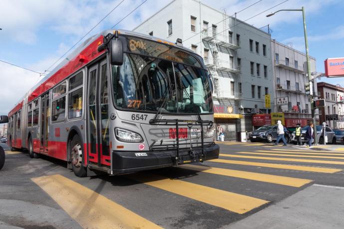 Photo showing an 8AX Bayshore Express articulated Muni bus on the road
