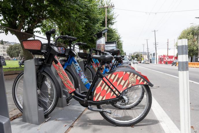 Photo showing e-bikes docked at docking station