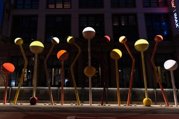 A light sculpture of colorful round orbs of light on bent and angled colored poles installed at Van Ness and O’Farrell streets