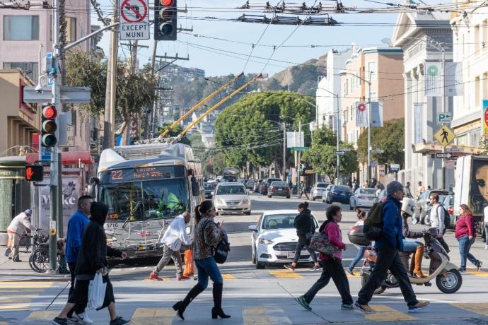 Pedestrians crossing the intersection at 16th and Mission streets.