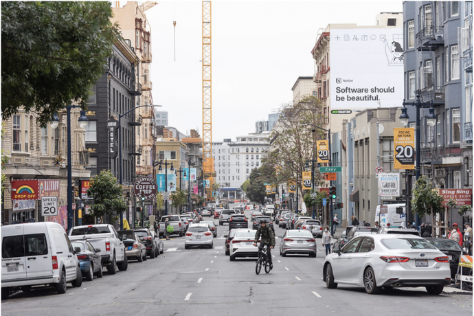 Showing three southbound travel lanes on Hyde Street with cars and a cyclist