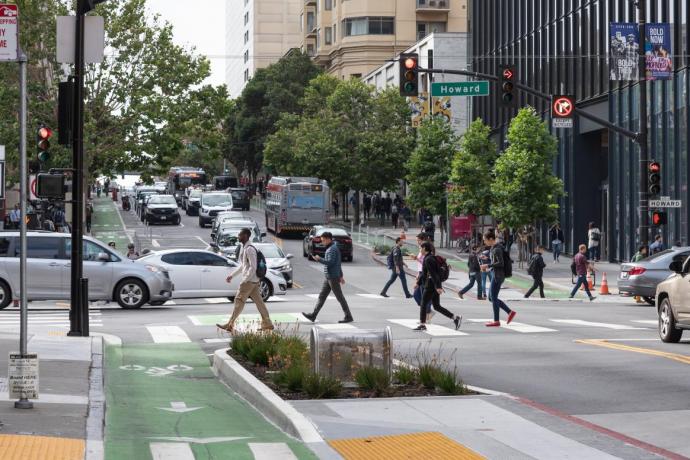 People walking across 2nd Street