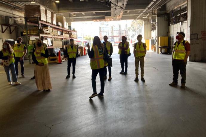 a group of people in a large garage space
