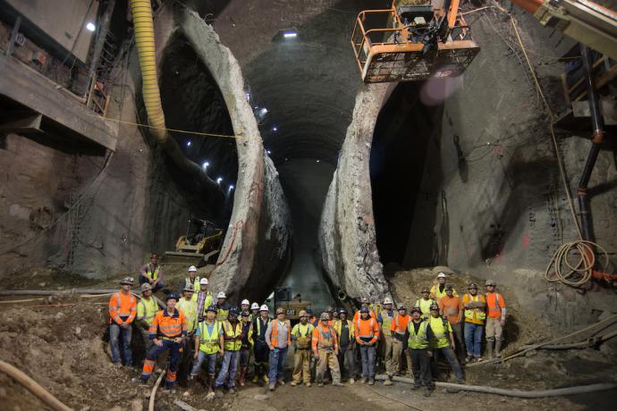 Construction and crew underground in a front of two boring entrances 