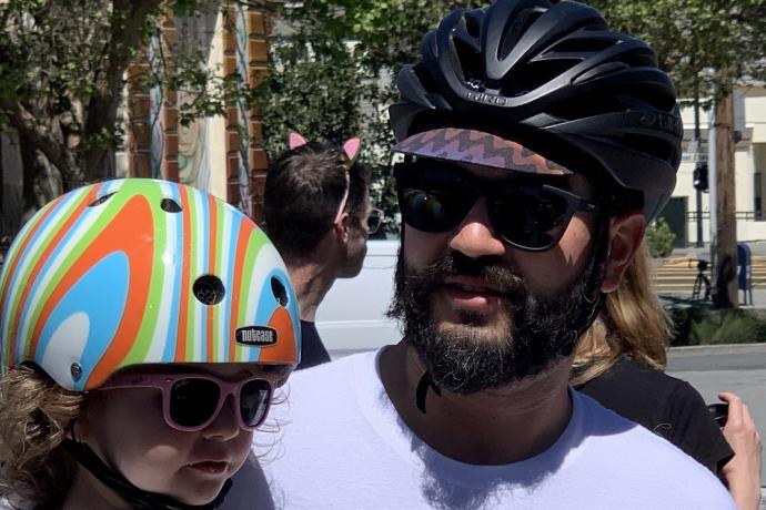 Father and daughter wearing bike helmets