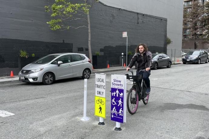 Cyclist rides across a Slow Street