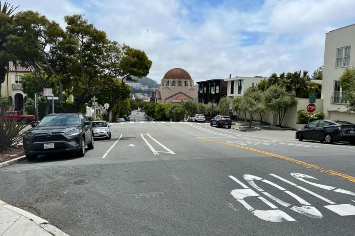 Street view of Arguello Boulevard with cars parked on either side.