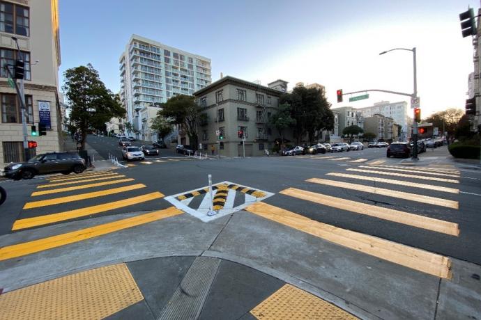 A crosswalk in San Francisco with upgraded safety installations.