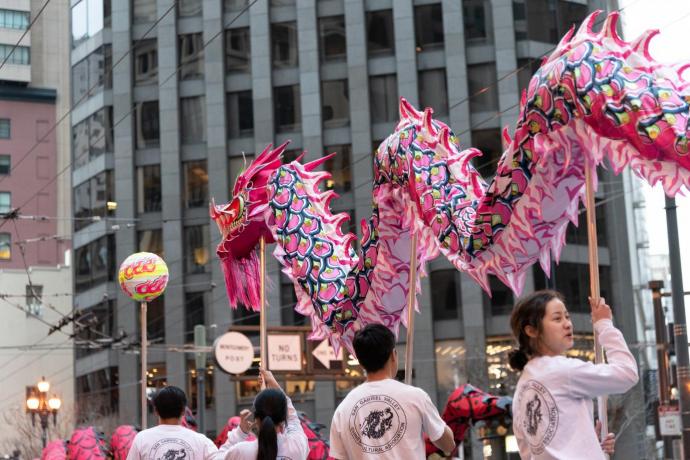 Parade-goers carry a Chinese dragon down a San Francisco street