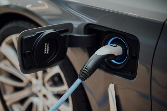 Photograph of charger connected into a personal vehicle. Photo by CHUTTERSNAP on Unsplash