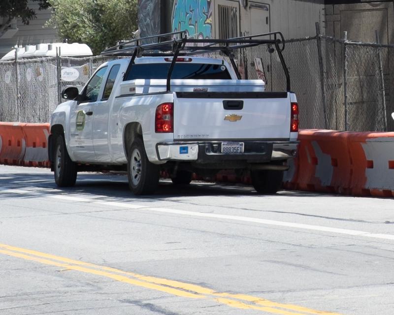 contractor truck parked on street outside construction zone