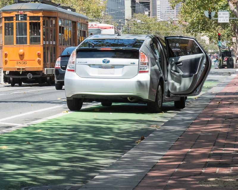 Uber driver blocking bike lane on Market Street while illegally loading passenger