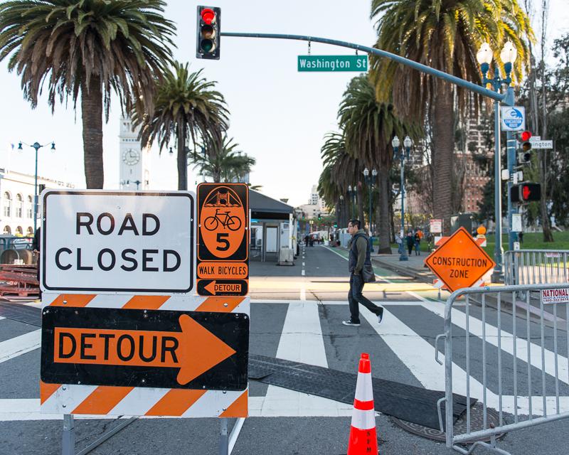 road closed sign with event construction in background