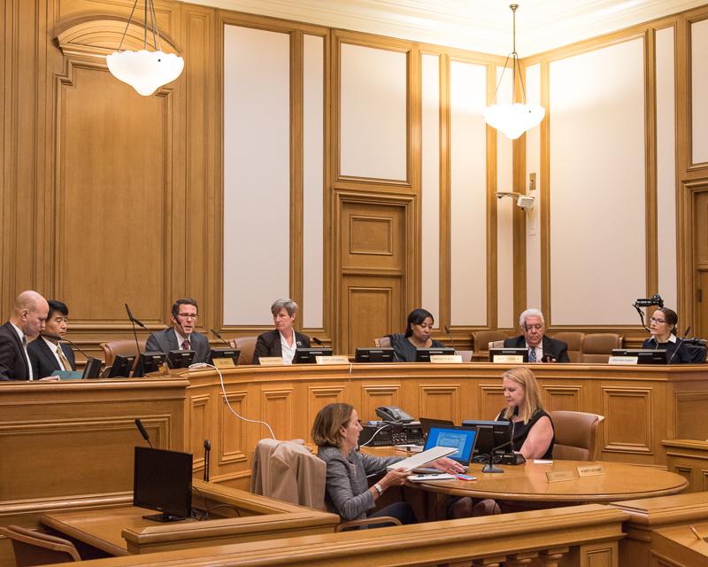 Group of people sitting at bench in board room