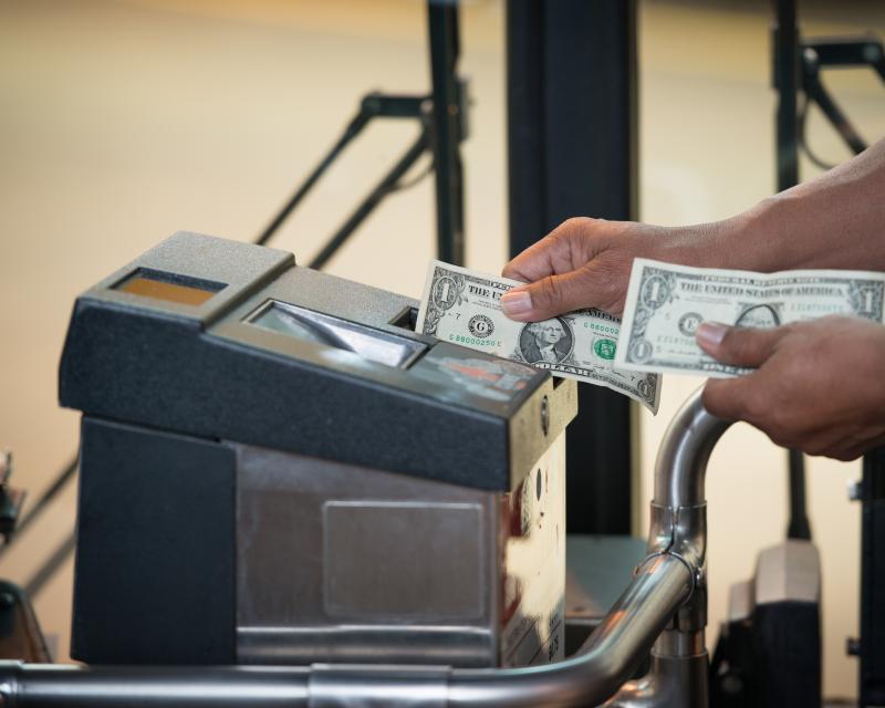 person buying fare with cash