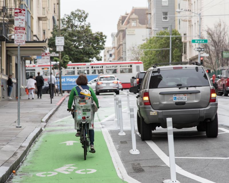 a person riding a bike on the newly reconfigured Turk Street