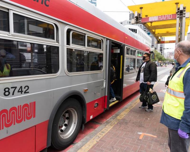 Passenger waiting to board bus during COVID-19