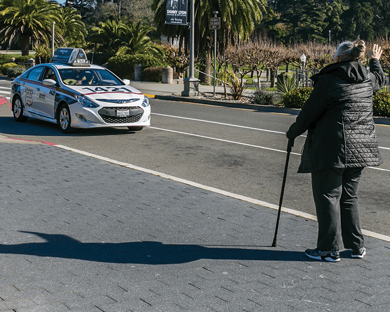 Person who is using a walker Hails a taxi cab