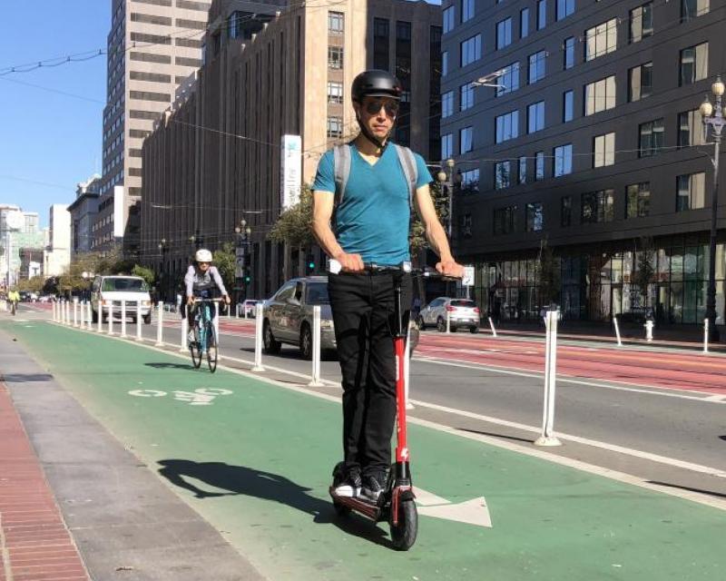 Scooter rider on green bike lane