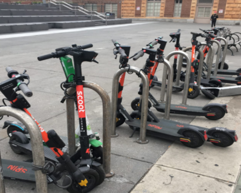 Scooters parked on bike racks