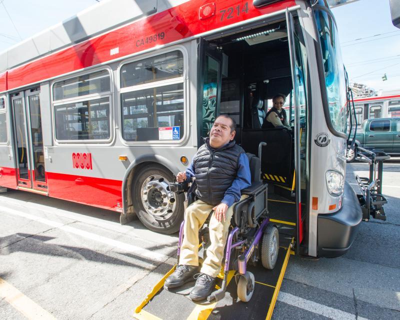 A customer in a wheelchair off-boards a low-floor vehicle using the accessible ramp