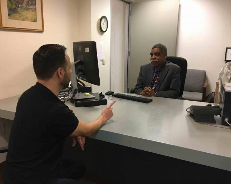 Image of a hearing officer reviewing a request with a member of the public