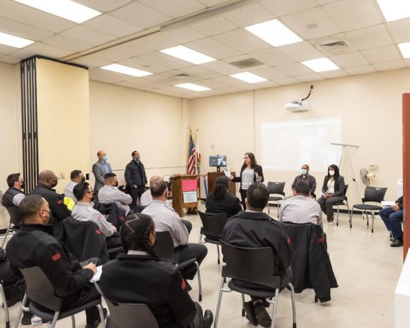 A speaker talk with SFMTA employees