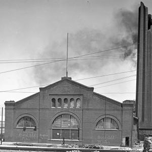 Black and white photo taken in June 1906 of a large brick building on Market and Valencia Streets.