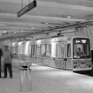 Black and white photo showing a Boeing LRV stopped at an empty platform in Embarcadero Muni Metro Station.