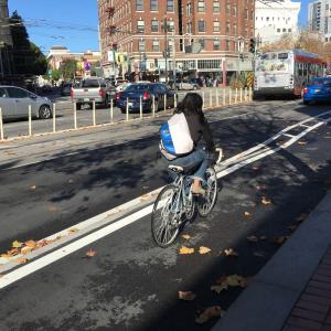 Cyclist using the newly installed raised bikeway