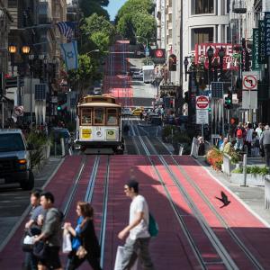 People crossing Powell Street, red lane pilot