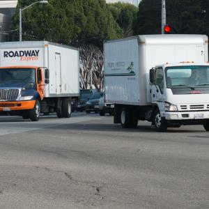 large trucks moving through city