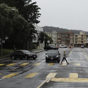 Woman crossing Bay Street in new high visibility school crosswalk