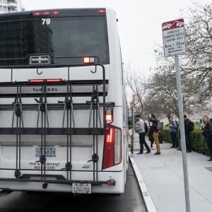 Photo of commuter shuttle picking up passengers.