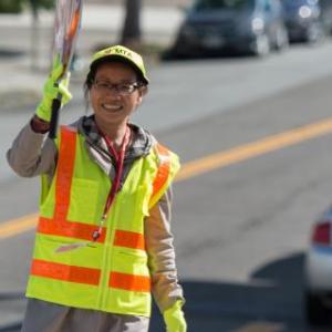 Crossing guard stands at an intersection