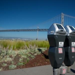 Picture of two parking meters on The Embarcadero with the Bay Bridge in the background