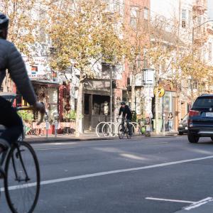 A cyclist and vehicle on Valencia Street