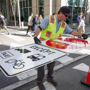 Crews installed signs along side streets in preparation for the changes on January 29.