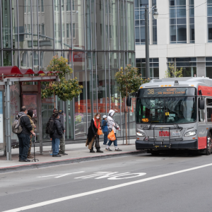 Passengers board 38 Geary on Geary at Van Ness