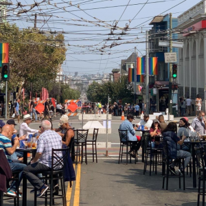 People enjoy the Shared Space at 18th and Castro streets