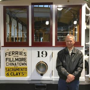 Person standing in front of a cable car