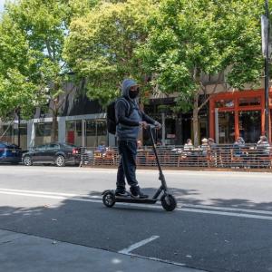 Photo of man riding scooter on Valencia Street