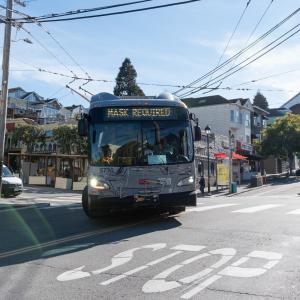 Bus with headway sign stating "mask required"