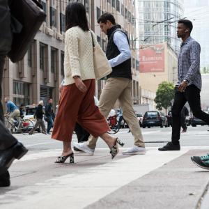 Pedestrians crossing 1st Street at Market Street